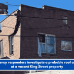 Emergency responders investigate a probable roof collapse at a vacant King Street property