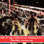 Interstate 77 sign crashes on car, trapping driver near Charlotte, rescuers say.