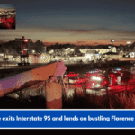 Vehicle exits Interstate 95 and lands on bustling Florence Street.